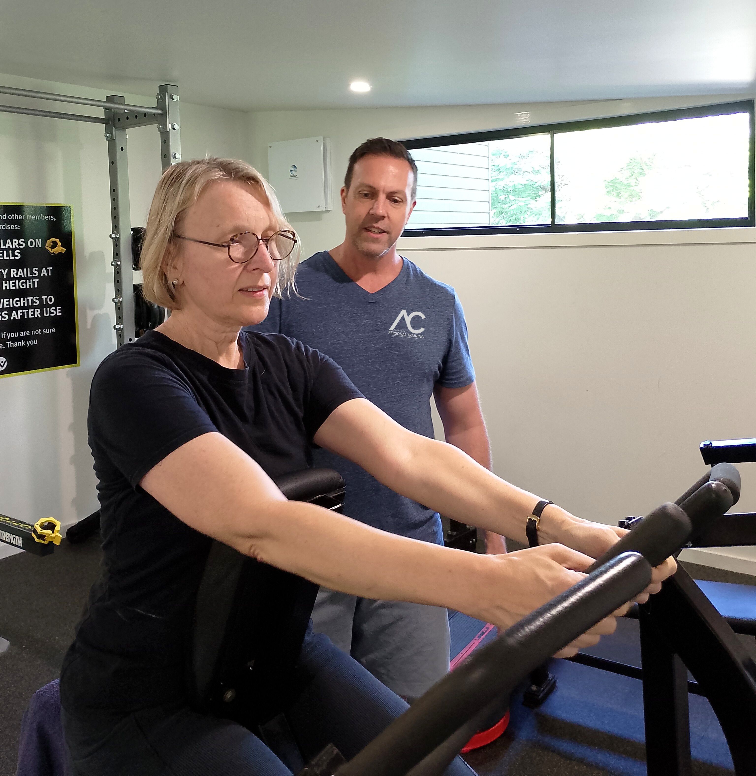 Kathryn using a shoulder press machine